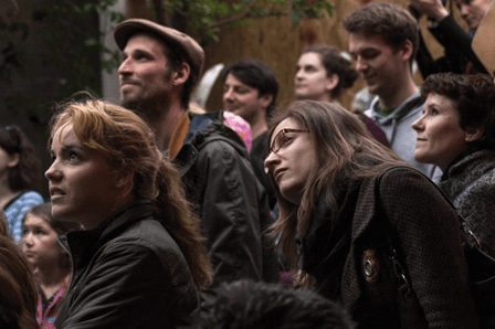 An audience engaged with site-specific theatre 